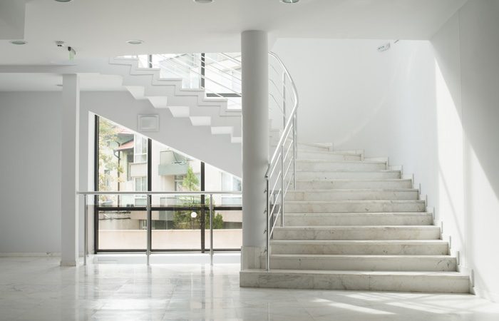 Interior of a building with white color walls. Flight of stairs